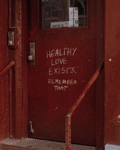 a red door with graffiti on it and the words healthy love exits, remember that