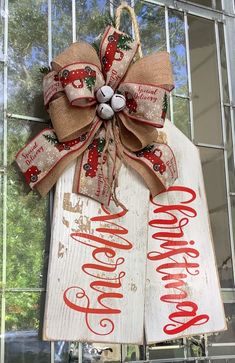 a christmas door hanger decorated with burlock and ribbon