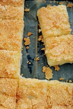 four pieces of bread sitting on top of a baking pan covered in crumbs