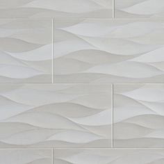 a white tile wall with wavy waves on it