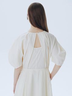 This is a modern and unique dress by ahwe that is made out of high quality and sturdy fabric. With minimal design detail and trendy mood, you can style it for your casual and refined daily outfit.- Voluminous lantern sleeves- U neckline with shirring- Dart detail on the sleeves- Diagonal pleat and cutout detail on the back Spring Cotton Puff Sleeve Dress With Lantern Sleeves, Elegant Cotton Midi Dress With Gathered Neckline, Chic Cotton Dresses With Bishop Sleeves, Billowy Lantern Sleeve Midi Dress For Spring, Billowy Cotton Dress With Balloon Sleeves, Billowy Midi Dress With Lantern Sleeves For Spring, Billowy Spring Midi Dress With Lantern Sleeves, Cotton Dresses With Gathered Balloon Sleeves, Cotton Puff Sleeve Dress For Brunch