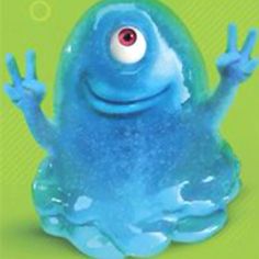 a blue frog with big eyes sitting on top of a green surface and holding his hands up in the air