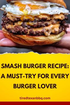 a hand holding a hamburger with cheese and an egg on it, in front of the caption reads smash burger recipe a must - try for every burger lover