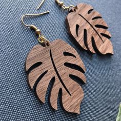 These laser cut monstera leaf earrings are made from your preference of 1/8" Maple or 1/8” Walnut hardwood. They’re light as a feather and ideal for daily wear! Choose either gold tone or silver tone hardware. Ear wires are stainless steel. Wood part of earring measures approximately 1.94” tall and 1.54” wide. Laser cut, crafted by hand and shipped from the United States. Wood grain varies with every piece and computer monitor settings can vary which may result in displaying slight color differe Snake Wood, Monstera Leaf Earrings, Laser Projects, Light As A Feather, Steel Wood, Monstera Leaf, Wood Earrings, Leaf Earrings, Computer Monitor