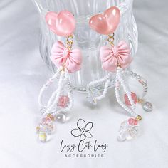 Introducing our Pink Love Delight Handcrafted Heart and Bow Earrings, featuring a charming composition of pink hearts, pink bows, and various other beads in the same color palette. These earrings are not only adorable but also highly creative, showcasing intricate design and exquisite detailing. Perfect for enhancing your attire on important occasions, the predominantly pink and white color scheme also makes them suitable for everyday wear. Versatile and stylish, these earrings are suitable for all occasions and age groups, effortlessly complementing a variety of outfits. Whether it's a formal affair or a casual outing, these earrings are sure to make a statement. Ideal for gifting, they appeal to individuals of all ages, symbolizing love and creativity. Elevate your accessory collection w Pink Feminine Earrings For Valentine's Day, Feminine Pink Earrings For Valentine's Day, Pink Feminine Heart Earrings For Valentine's Day, Pink Heart Earrings For Wedding On Valentine's Day, Cute Pink Earrings For Wedding, Sweet Pink Party Earrings, Pink Handmade Heart Earrings For Party, Pink Heart Beads Earrings For Gifts, Cute Pink Wedding Earrings