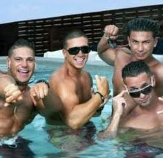 three men are in the pool posing for a photo