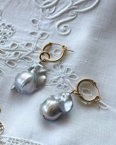 Elevate your style with our Grey Joelle Earrings. These gold filled hoops with baroque pearls add luxury and sophistication to any outfit. Stand out with this timeless and exclusive design, perfect for any occasion. Experience the beauty and elegance of baroque pearls with Joelle Earrings. Wedding Nickel Free Huggie Hoop Earrings, Small Hoop Earrings For Wedding, Small Hoop Pierced Earrings For Wedding, Wedding Gold Plated Small Hoop Earrings, Nickel-free Huggie Hoop Earrings For Wedding, Nickel Free 14k Gold Filled Earrings For Wedding, Gold Plated Hoop Earrings With Ear Wire For Wedding, Wedding Huggie Earrings With Ear Wire, Small Hoop Wedding Jewelry