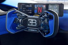 the steering wheel and dashboard of a sports car with digital numbers on it's display