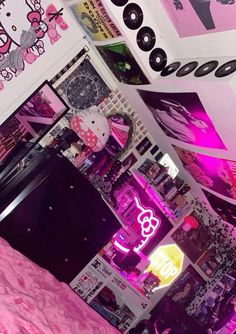 a bedroom with hello kitty wallpaper and pink bedding, neon lights and posters on the walls