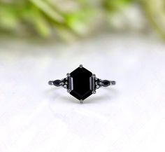 Ring Specifications & Details: SKU: KRG 8142 Engagement/Wedding/Bridal Ring Stone Size: 10.00X7.00 mm Accents:  Black Spinal Gemstone Stone Type: Black Onyx Gemstone Stone: Hexagon Shape Natural Black Onyx Gemstone Metal Used: 925 Sterling Silver We apply 2.5 micron of thicker plating on our rings.  You may also favorite our studio for continuous updates on new designs and special discount coupons. Their would be special sale in the beginning of every month.  We work in all semi precious and precious gemstones so you may reach to us if you want any particular gemstone in this jewelry article. We can also make custom product for you. Black Formal Jewelry With Accent Stones, Black Bezel Set Jewelry For Anniversary, Black Spinel Gemstone Jewelry For Wedding, Black Oval Jewelry With Bezel Setting, Onyx Gemstone Rings For Wedding, Black Octagon Rings As Gifts, Black Sterling Silver Jewelry For Wedding, Black Emerald-cut Gemstone Jewelry, Black Jewelry With Bezel Setting For Gift