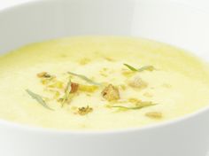 a white bowl filled with soup on top of a table