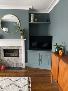 a living room with blue walls and a fireplace