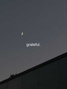 the moon is shining in the sky above a building with writing on it that reads grateful