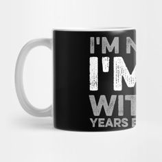 a black and white coffee mug with the words i'm not in my wit years written on it