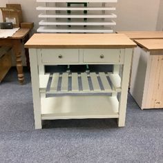 a small kitchen island with drawers and shelves