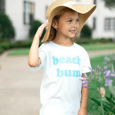 Spending your summer at the beach calls for this adorable crewneck short sleeve shirt! Natural tee with Teal letters 100% Cotton Machine wash cold, dry flat Iron inside out Made in the USA Beach Day School, Flower Girl Shirts, Halloween Adventure, Beach Tee, Daisy Girl, Summer Graphic Tee, Arlington Va, Beach Kids, Girl Birthday Party