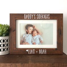 a wooden frame with the words daddy's sheekks and a photo of a baby