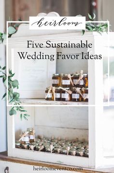 a white shelf filled with wedding favors and jars on top of it, surrounded by greenery