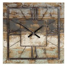 a square metal clock sitting on top of a wooden wall