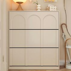 a white cabinet sitting in the corner of a room