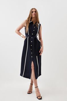 Feel Confident In Our Midi Dress, With A Shirt Style Design Featuring A Formal Collar, As Well As A Belted Waist For A Cinched Silhouette, And A Long, Flared Skirt. Style It With Block Heels Or Ankle Boots For A Look Perfect For Office Days, Then Wear It With Heeled Boots Or Strappy Heels For An Evening Look. Soft Tailored Pipe Detail Sleeveless Shirt Dress Flattering Fit And Flare Silhouette Unique Contrasting Lining V Neckline Formal Collar Detailing Belted Waist Feature Relaxed, Flared Skirt Black Shirt Dresses, White Shirt Dresses, Long Flared Skirt, Pleated Shirt Dress, Sleeveless Shirt Dress, Street Dress, Short Sleeve Shift Dress, Soft Tailoring, Skirt Style