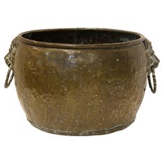 an old metal pot with handles on it