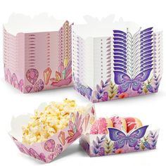 three paper boxes filled with different types of food on top of each other and one has a butterfly design