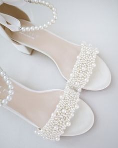 the bride's shoes are adorned with pearls