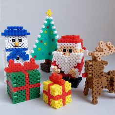 an image of christmas decorations made out of legos and plastic beads with santa claus