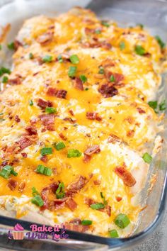 a casserole dish with bacon, cheese and green onions in it is ready to be eaten