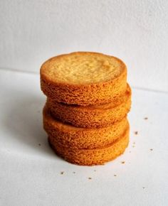 a stack of four cookies sitting on top of a white table next to each other