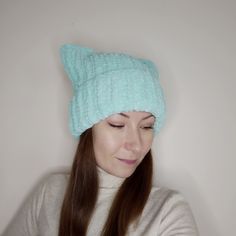 a woman with long hair wearing a knitted hat