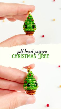 a hand holding a green beaded christmas tree ornament