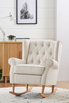 a white rocking chair sitting on top of a rug