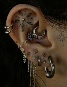 a woman with many piercings on her ear