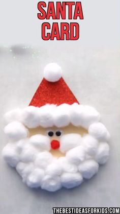 the santa card is made out of foam and has a red hat on it's head