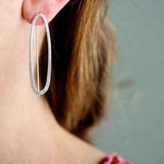 These earrings are curvy and sparkly with a decidedly modern edge - sure to please the art and design lover. The shimmering texture on the metal adds a little something unexpected, and is sure to draw lots of compliments. Featuring a narrow oval with subtle sparkle texture that catches the eye on the front, paired with a visible threader ear wire in the back, this design creates an intriguing and dimensional visual statement. 1.5" long with fixed wire threader ear wire. Available in sterling sil Sparkle Texture, Southern Vermont, Long Dangle Earrings, Mixed Metals, Art And Design, Ear Wire, Long Earrings, Sterling Earrings, To Draw