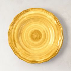 a yellow plate sitting on top of a white table