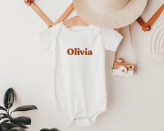 Looking for a special gift? Our personalised baby onesie® is the ideal choice! Customise this onesie® with your own text and make it the most memorable gift for a new mama, baby announcement, or family photo tee! The perfect gift for a newborn or any special little one in your life, our personalised onesie® is printed with eco-friendly inks on 100% cotton, for the softest feel. The Details: * Super soft and comfy!  * Lightweight and breathable * 100% cotton for the softest feel imaginable * The Personalized White Bodysuit For Gift, White Onesie With Name Print For Gift, Personalized White Onesie As A Gift, Personalized White Onesie As Gift, Casual Personalized White Onesie, White Personalized Short Sleeve Onesie, Casual White Personalized Onesie, Customizable White Onesie As A Gift, Customizable White Onesie As Gift