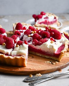 raspberry and white chocolate tart on a cutting board with one slice taken out