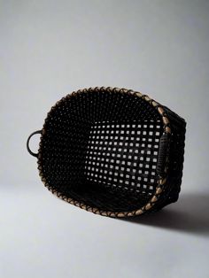 a black and brown basket sitting on top of a table