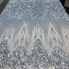 the table cloth has silver sequins on it