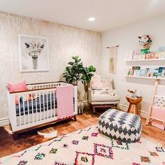 a baby's room is decorated in pink and white