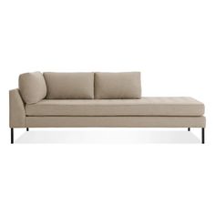 a beige couch sitting on top of a white floor