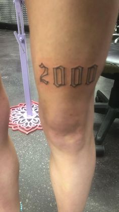 a woman's legs with the word 2013 tattooed on them