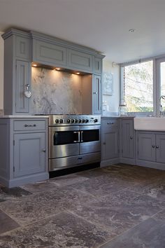 Stainless steel oven sits within bespoke painted kitchen cabinets on mantle housing extractor Presentation Room, Reclaimed Kitchen, Stainless Steel Range, Stainless Steel Oven, Painted Kitchen, Range Cooker