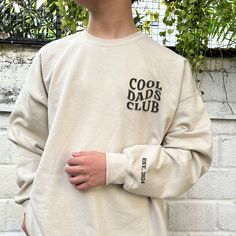 Hop into the exclusive circle where fashion and fun collide - welcome to the Cool Dads Club! Our embroidered club shirt is not just attire; it's your new badge of honor. Flaunting a sleek text design, it's for the dad who's as comfortable cracking a joke as he is fixing a bike. This isn't just a shirt; it's a statement that says, "I'm not a regular dad; I'm a cool dad." Embroidered Excellence for Everyday Heroes Crafted with precision, our Cool Dads Club shirt features detailed embroidery that m Hero Crafts, Detailed Embroidery, Dad Fashion, Everyday Heroes, Club Sweatshirts, Kids Names, Special Quotes, Club Shirts, Comfort Color