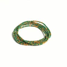 Beautiful delicate wrap bracelet, wraps around your wrist 5 times. Lovely color combination of green with a hint of golden seed beads which gives the bracelet a lovely sparkle. M A T E R I A L * Delica Seed beads from Miyuki ( 2 mm) green & gold * Very strong elastic S I Z E Size medium, 86 cm ( 34 inch), 6.7 inch when wrapped, fits the normal to small wrist. Can be made in any size ( please sent me a message with your order and it will be made for you) S H I P P I N G * All orders are wrapp Gold Multi-strand Wrap Bracelet For Gift, Adjustable Multi-strand Wrap Bracelet With Tiny Beads, Green Multi-strand Beaded Bracelets Gift, Multicolor Beaded Multi-strand Wrap Bracelet, Green Multi-strand Bohemian Wrap Bracelet, Western Bracelets, Peridot Bracelet, Essential Oil Diffuser Bracelet, Boho Wrap Bracelet