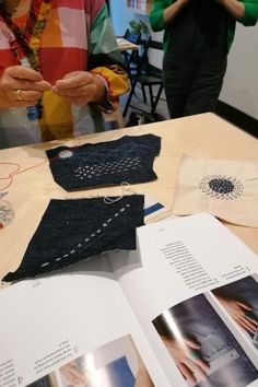 an open book on sewing with people in the background