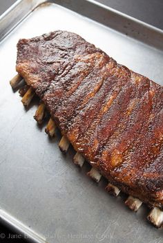 a large piece of meat sitting on top of a metal pan with toothpicks sticking out of it